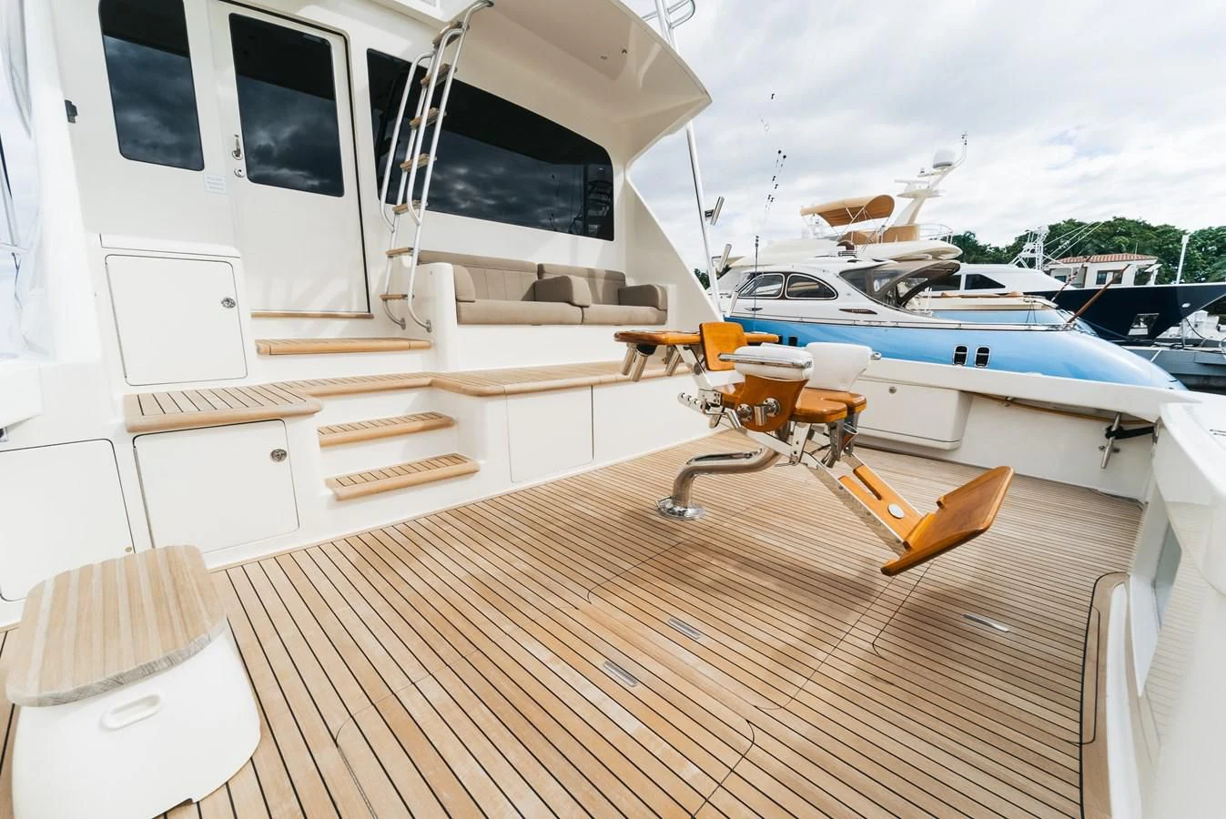 a deck with a boat and a table on it aboard RHINO FISH Yacht for Sale
