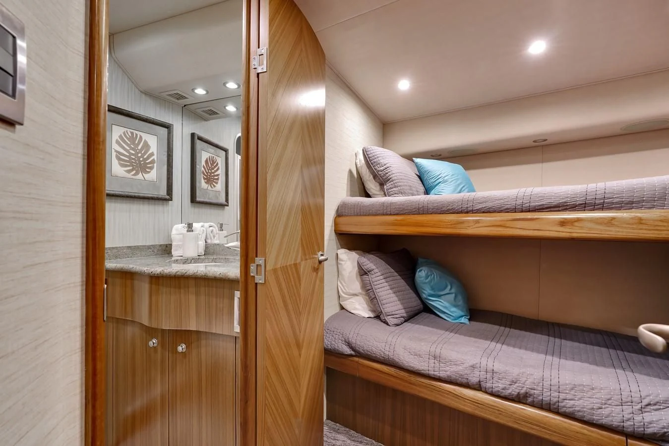 a bed with a blue pillow aboard RHINO FISH Yacht for Sale