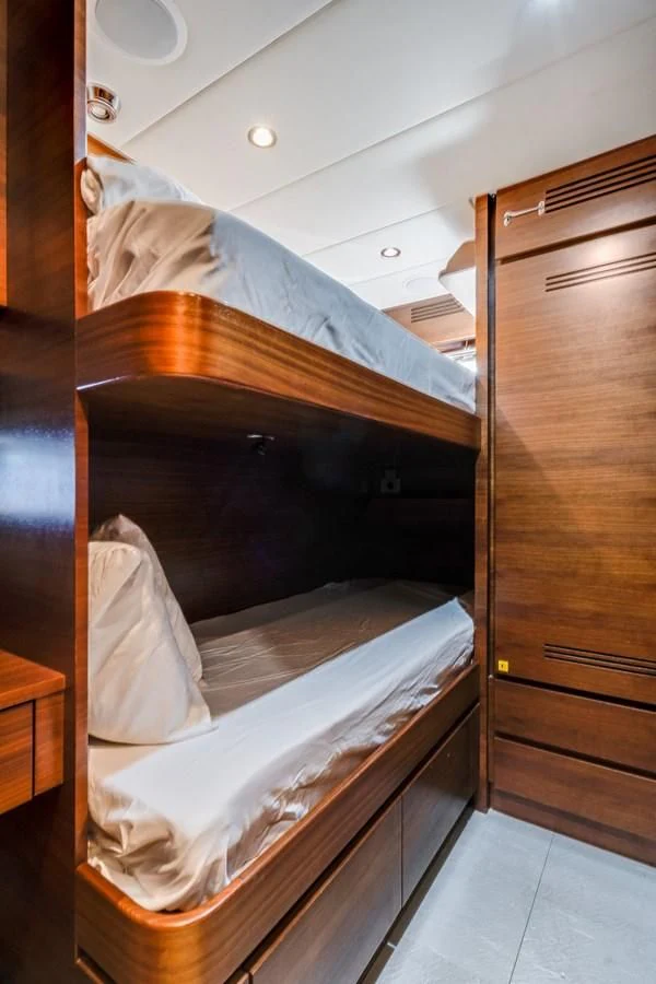 a bed with a white sheet on it aboard ENCORE Yacht for Sale