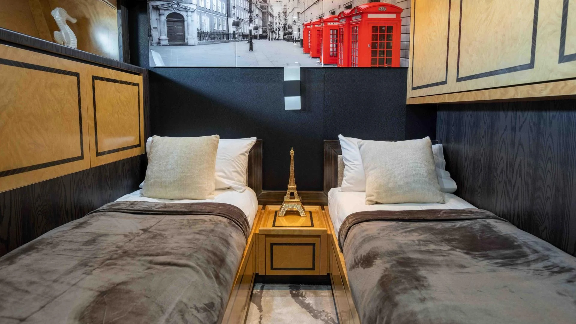 a room with beds and a table aboard ENCORE Yacht for Sale