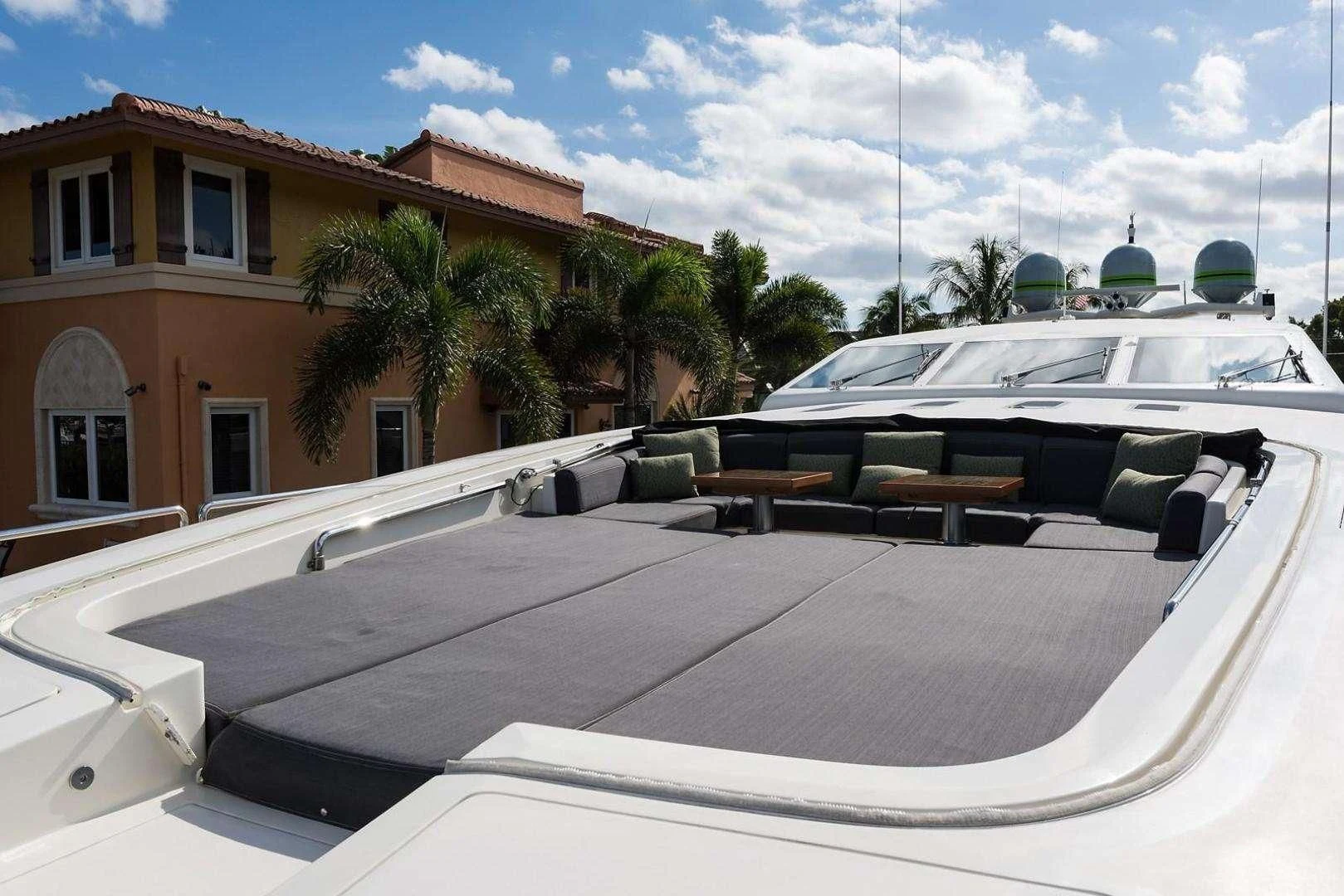 a rooftop with a pool and a building in the background aboard ENCORE Yacht for Sale
