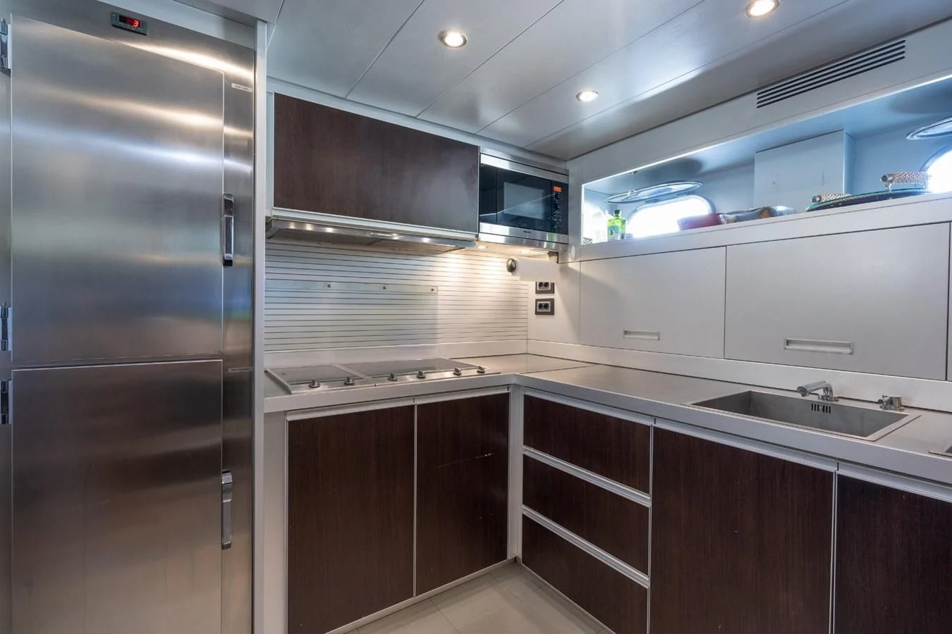 a kitchen with a stainless steel refrigerator aboard ENCORE Yacht for Sale