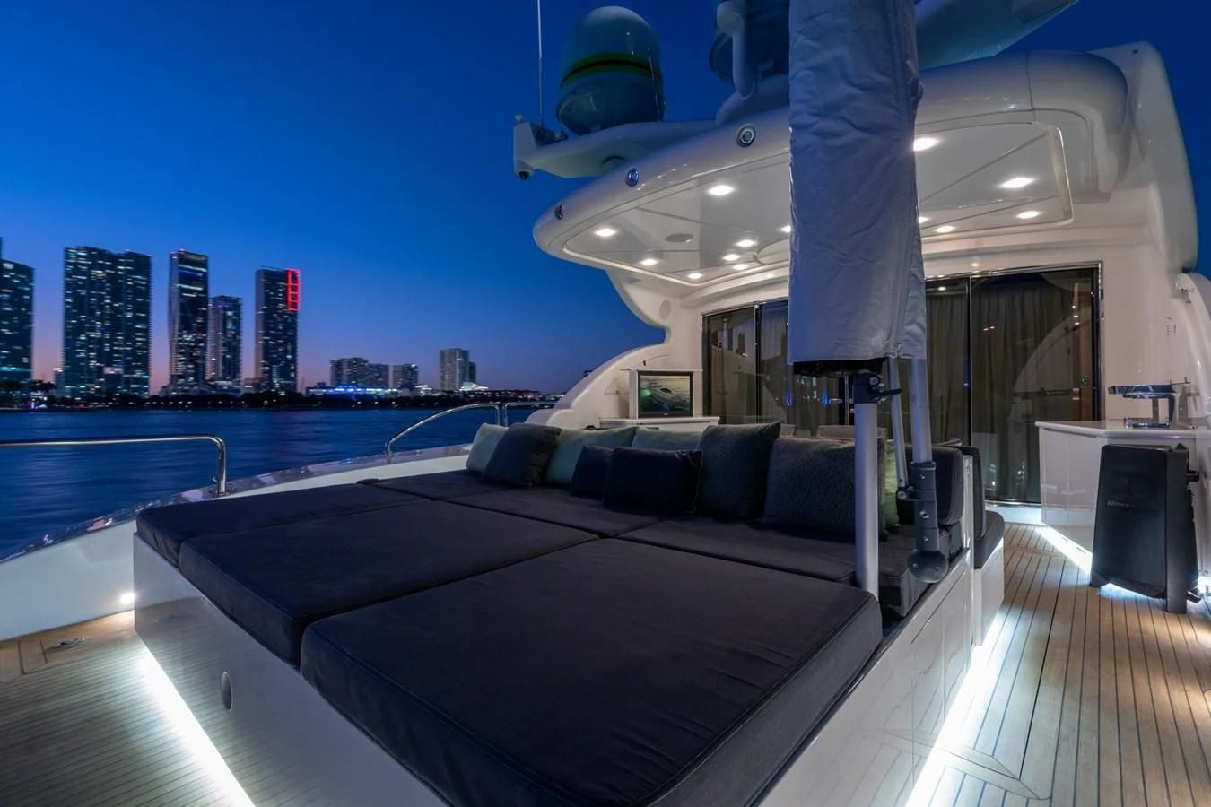 a large lounge chair on a deck overlooking a city aboard ENCORE Yacht for Sale