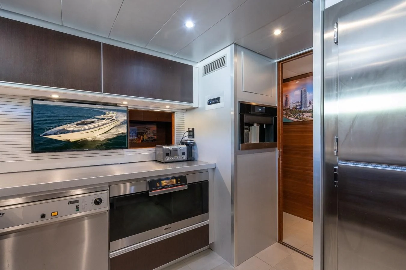 a kitchen with a large screen aboard ENCORE Yacht for Sale