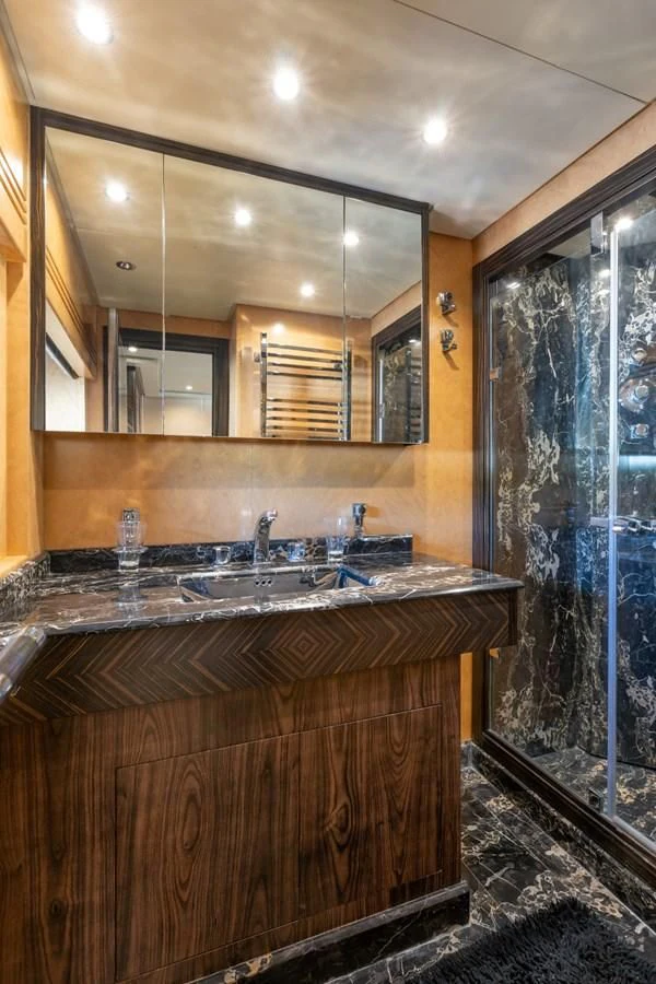 a bathroom with a sink and a large mirror aboard ENCORE Yacht for Sale