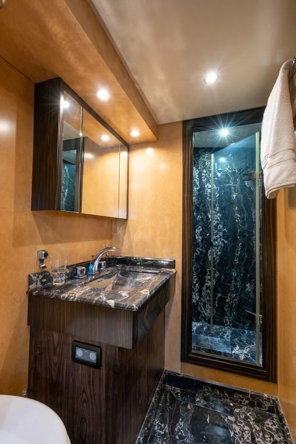 a bathroom with a large mirror aboard ENCORE Yacht for Sale