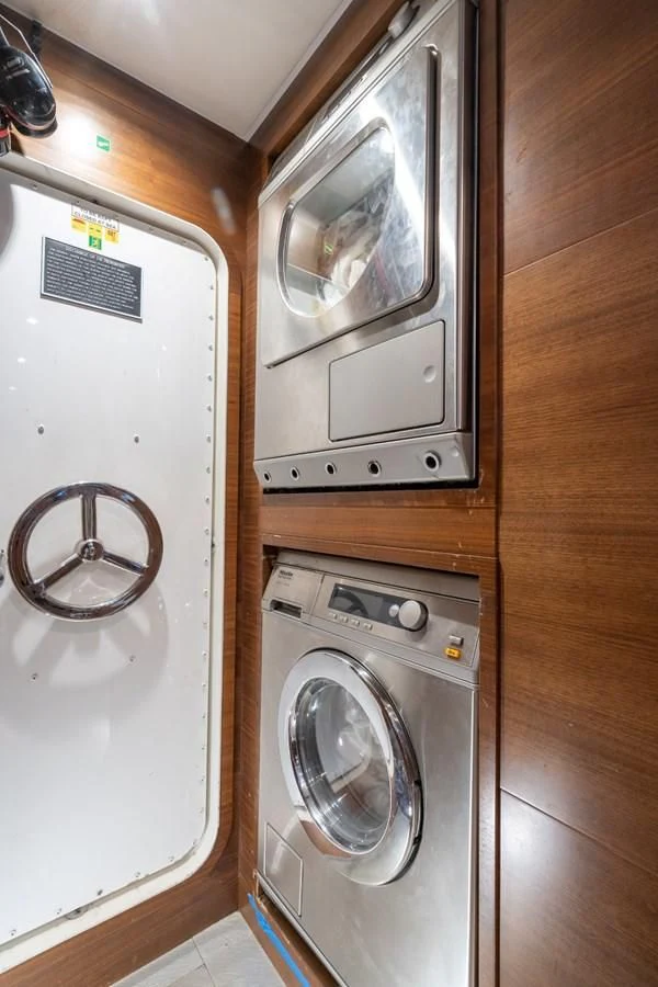 a washer and dryer in a room aboard ENCORE Yacht for Sale