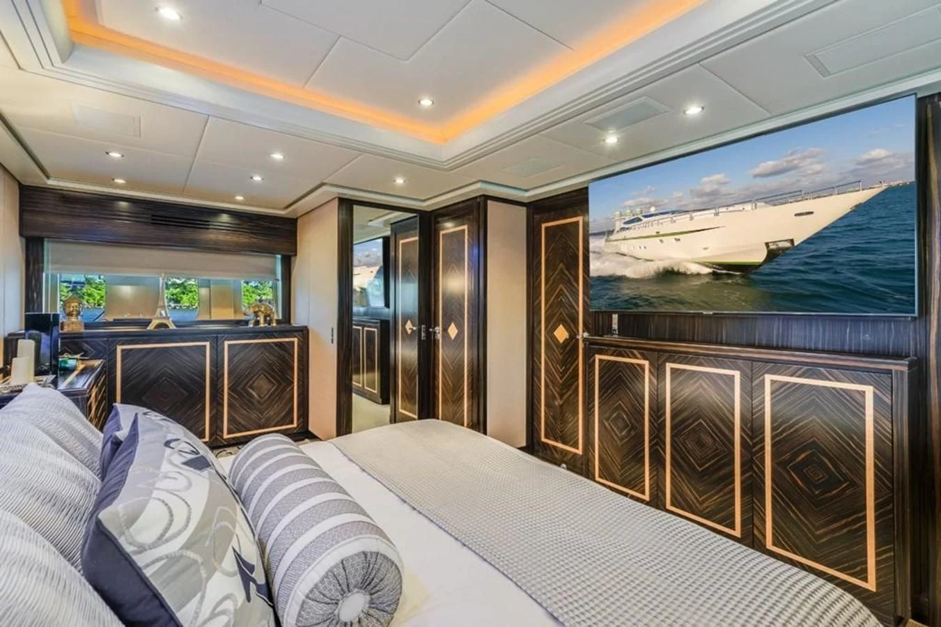 a room with a bed and a large fish tank aboard ENCORE Yacht for Sale
