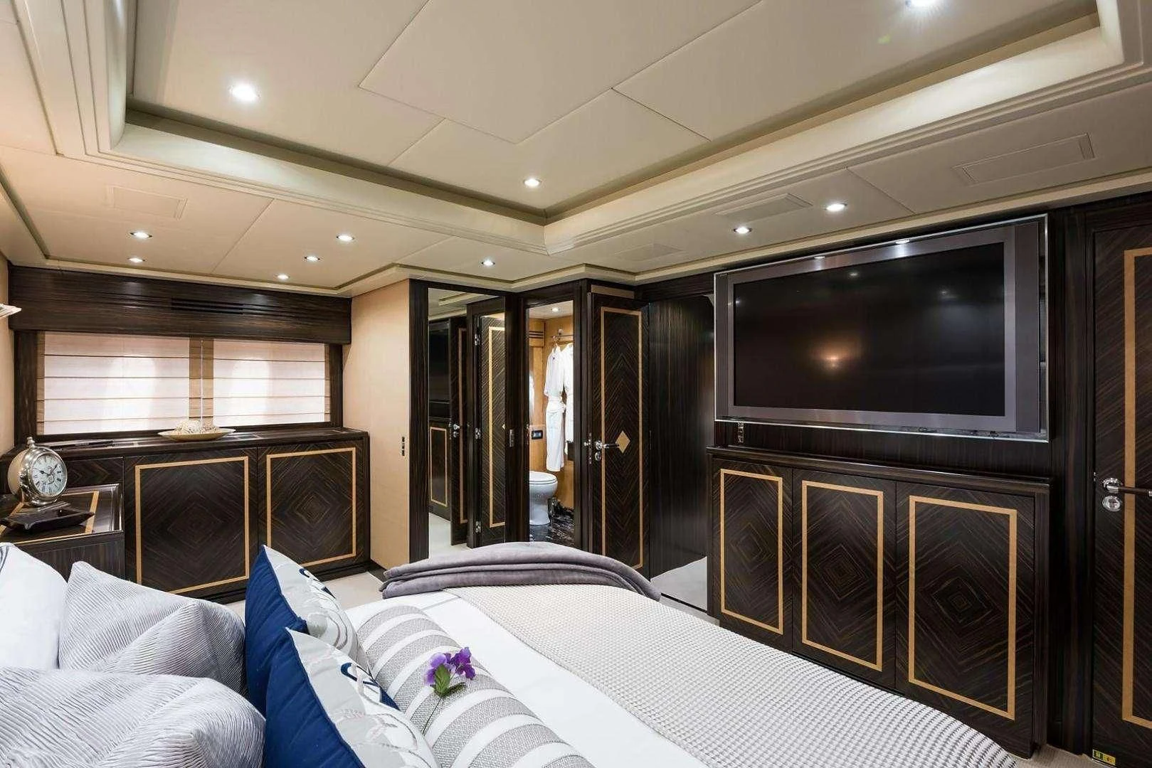 a hotel room with a bed and tv aboard ENCORE Yacht for Sale