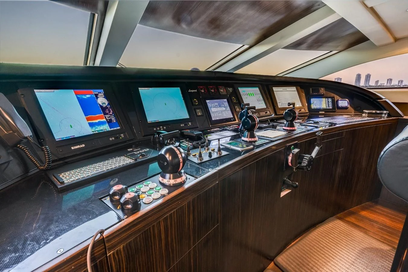 a control room with many monitors aboard ENCORE Yacht for Sale