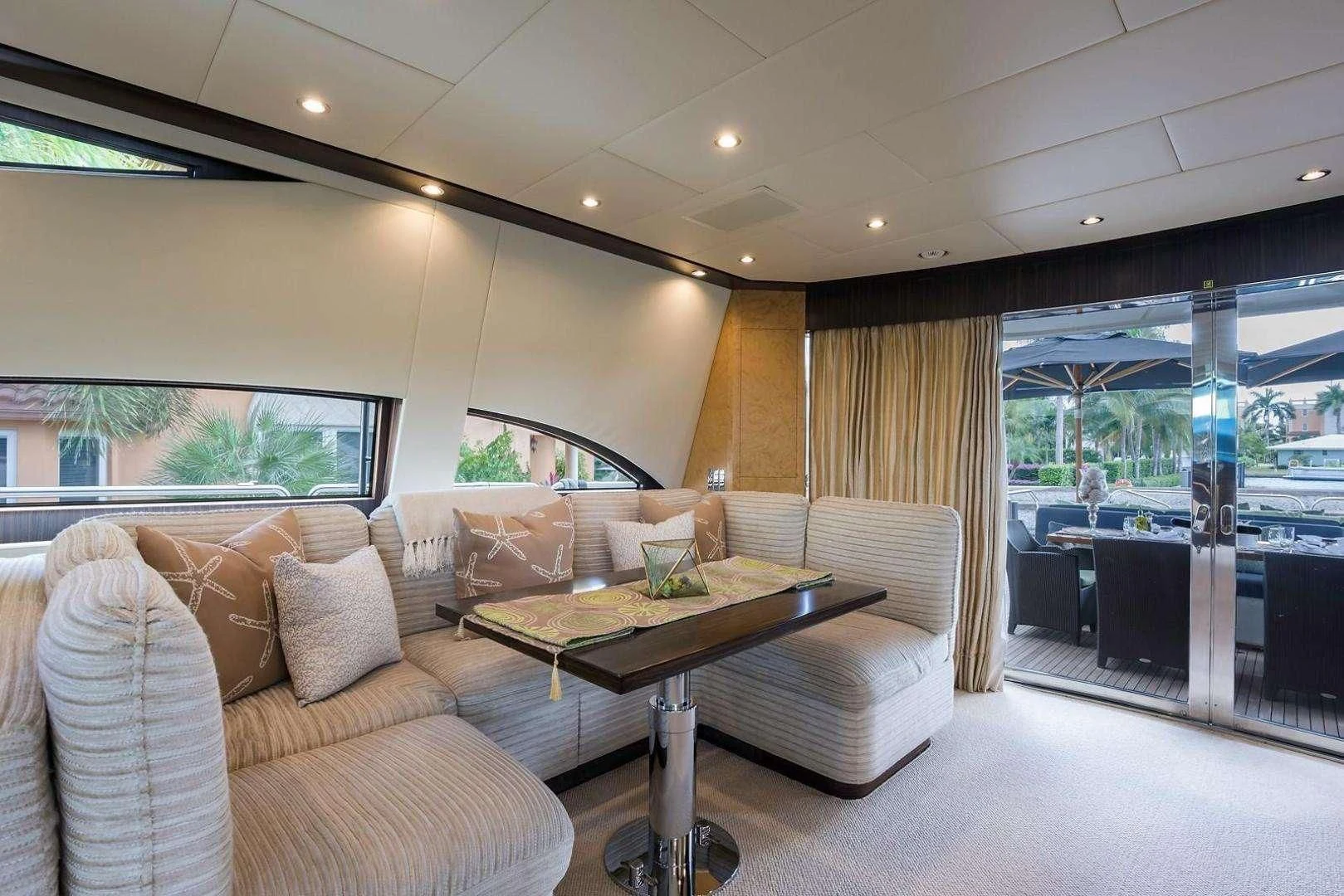 a living room with a large glass door aboard ENCORE Yacht for Sale