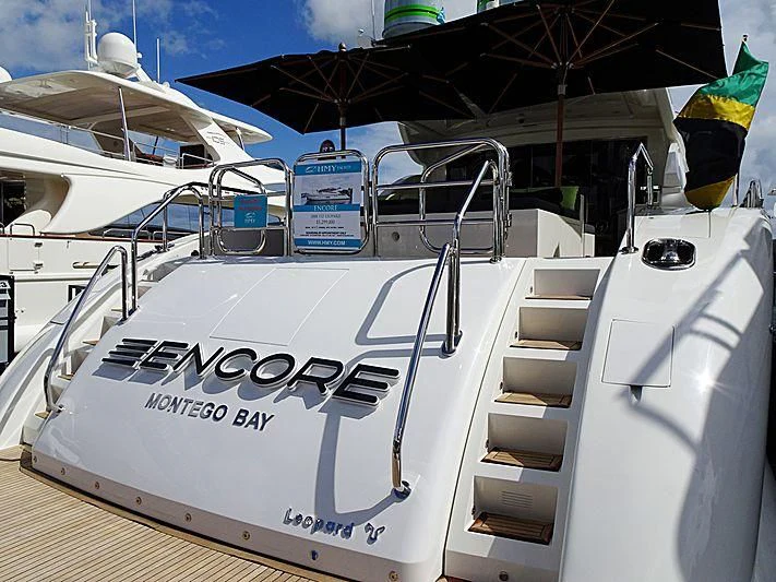 a white boat with a sign on it aboard ENCORE Yacht for Sale