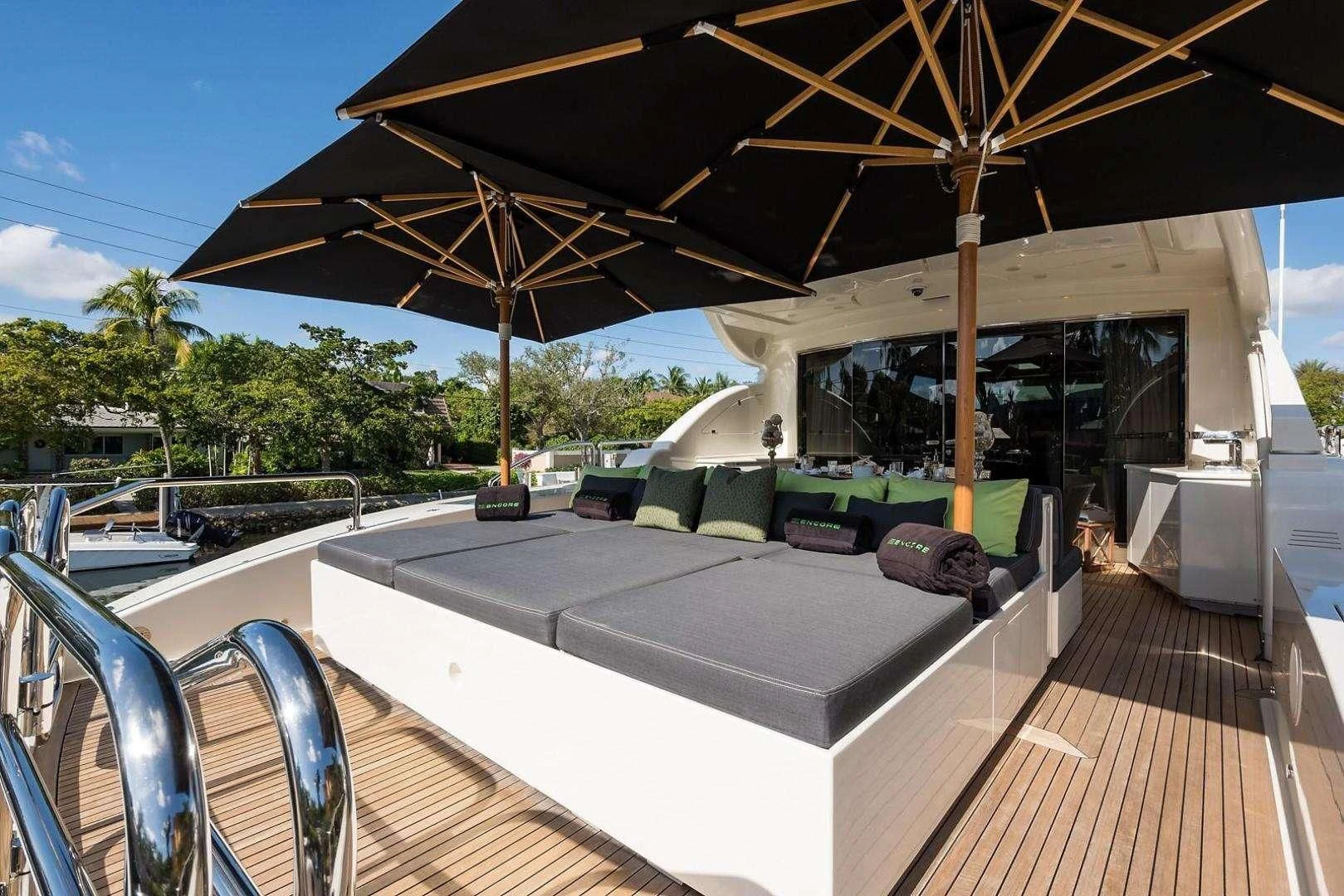 a covered deck with a large umbrella aboard ENCORE Yacht for Sale