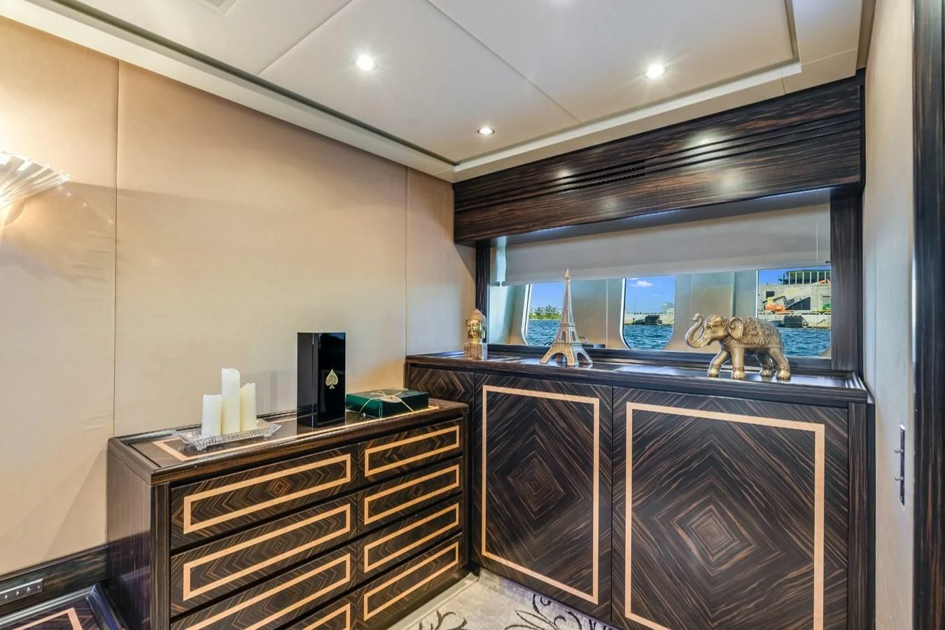 a room with a glass wall and a counter with a sink and a mirror aboard ENCORE Yacht for Sale