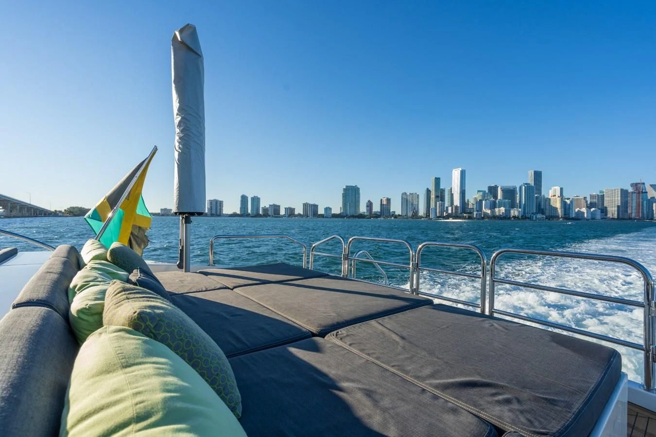 a person lying on a bench overlooking a city aboard ENCORE Yacht for Sale
