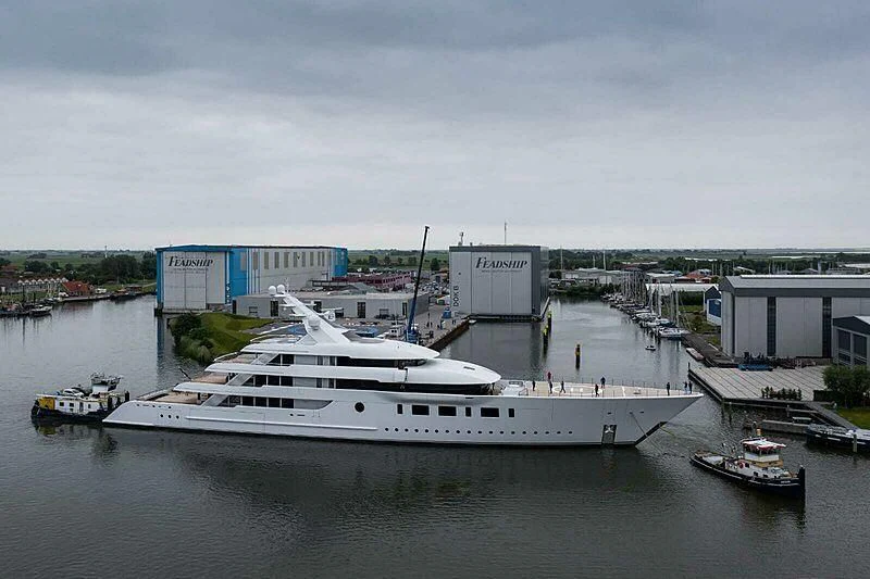 a large white boat in a harbor aboard BLISS Yacht for Sale