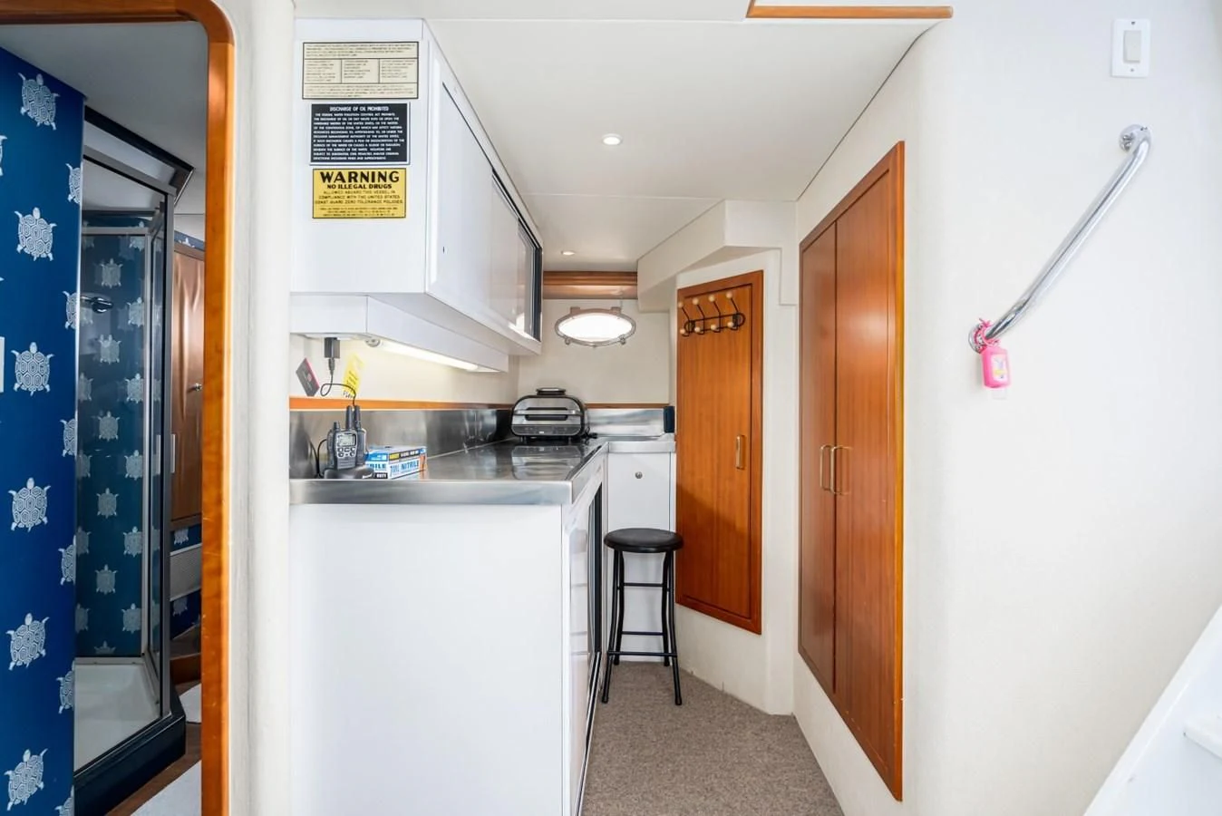 a kitchen with a blue wall aboard MAHANA Yacht for Sale