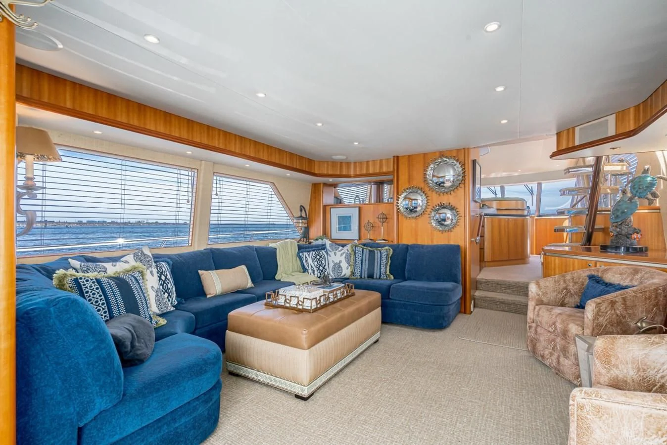 a living room with a blue couch aboard MAHANA Yacht for Sale