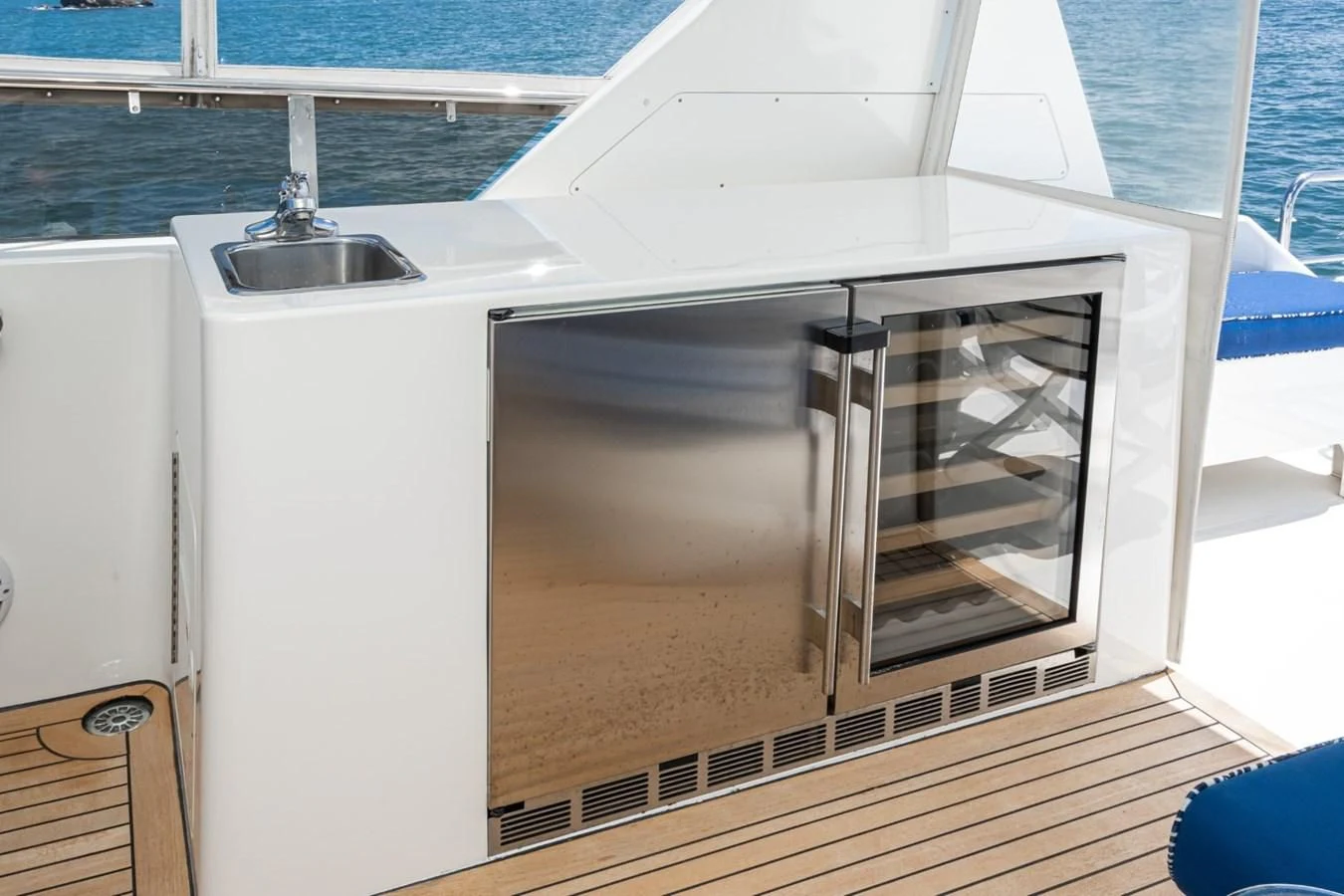 a white kitchen with a glass door aboard MAHANA Yacht for Sale