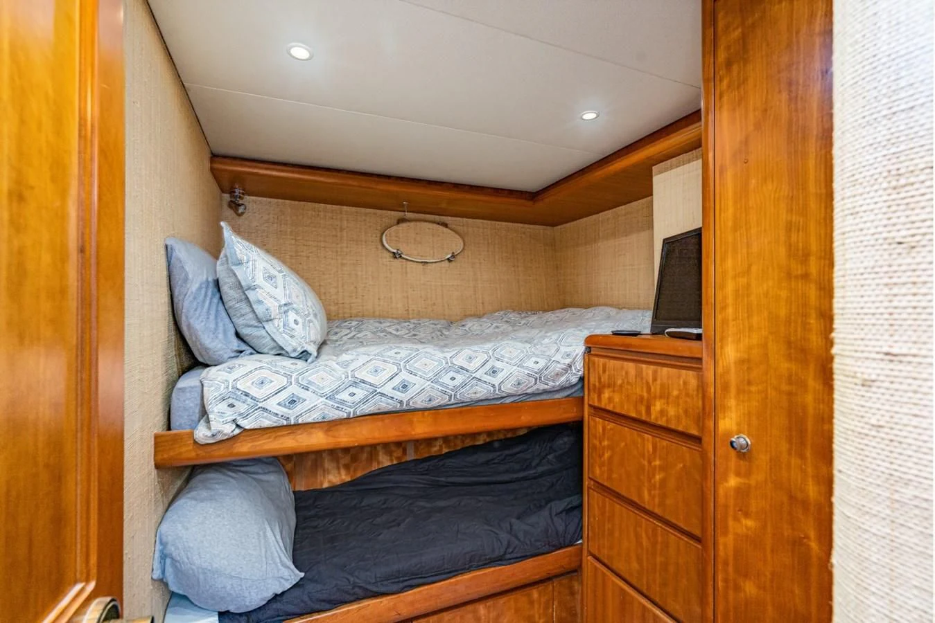 a bedroom with a bed and a desk aboard MAHANA Yacht for Sale