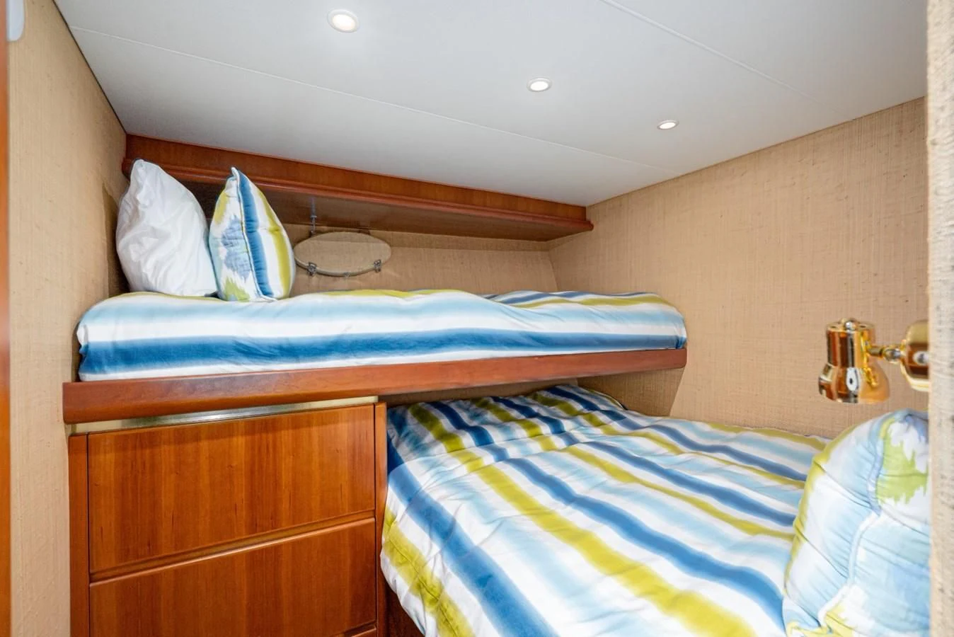 a bunk bed with a blue and white striped pillow aboard MAHANA Yacht for Sale