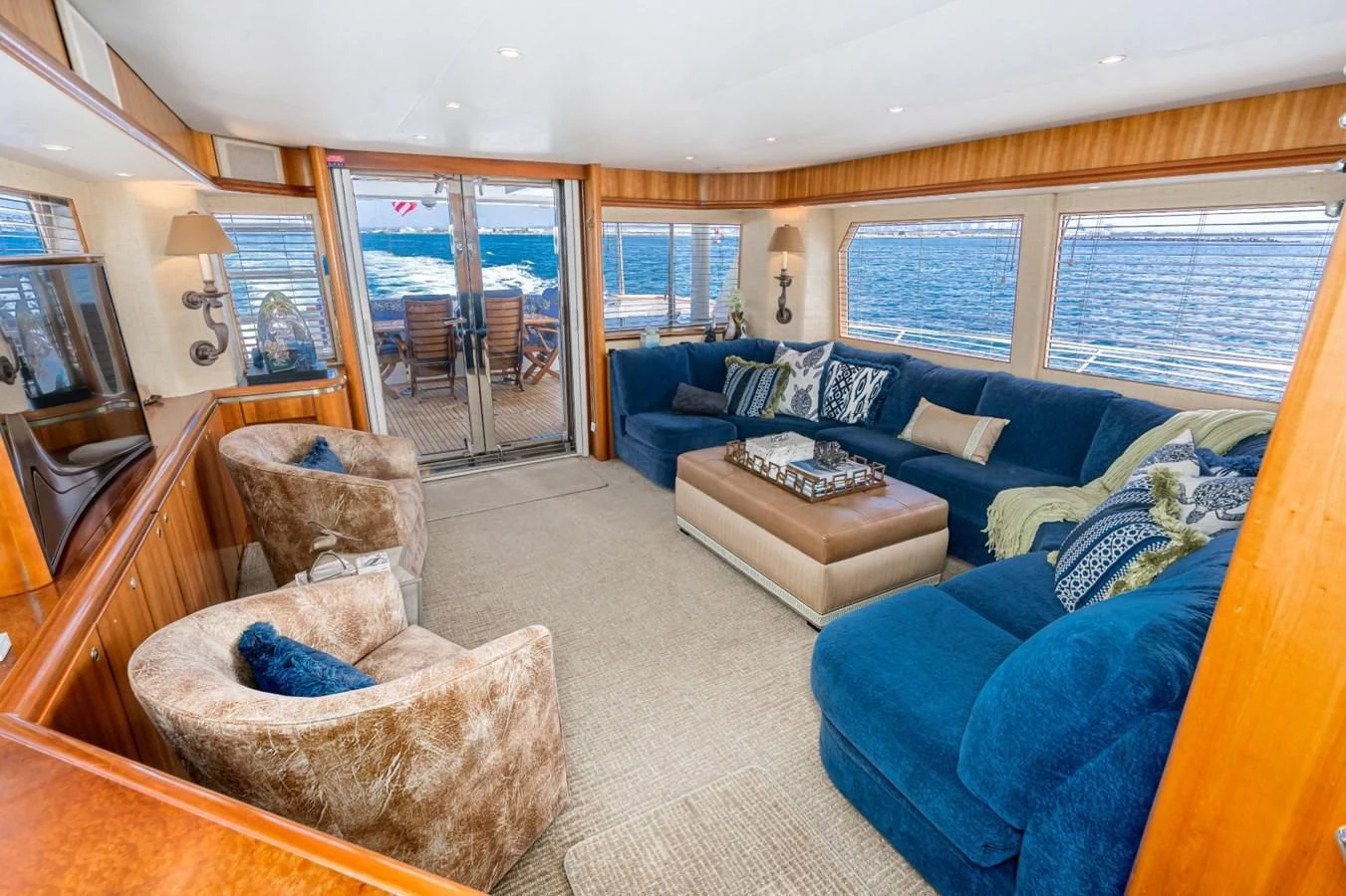 a living room with a blue couch aboard MAHANA Yacht for Sale