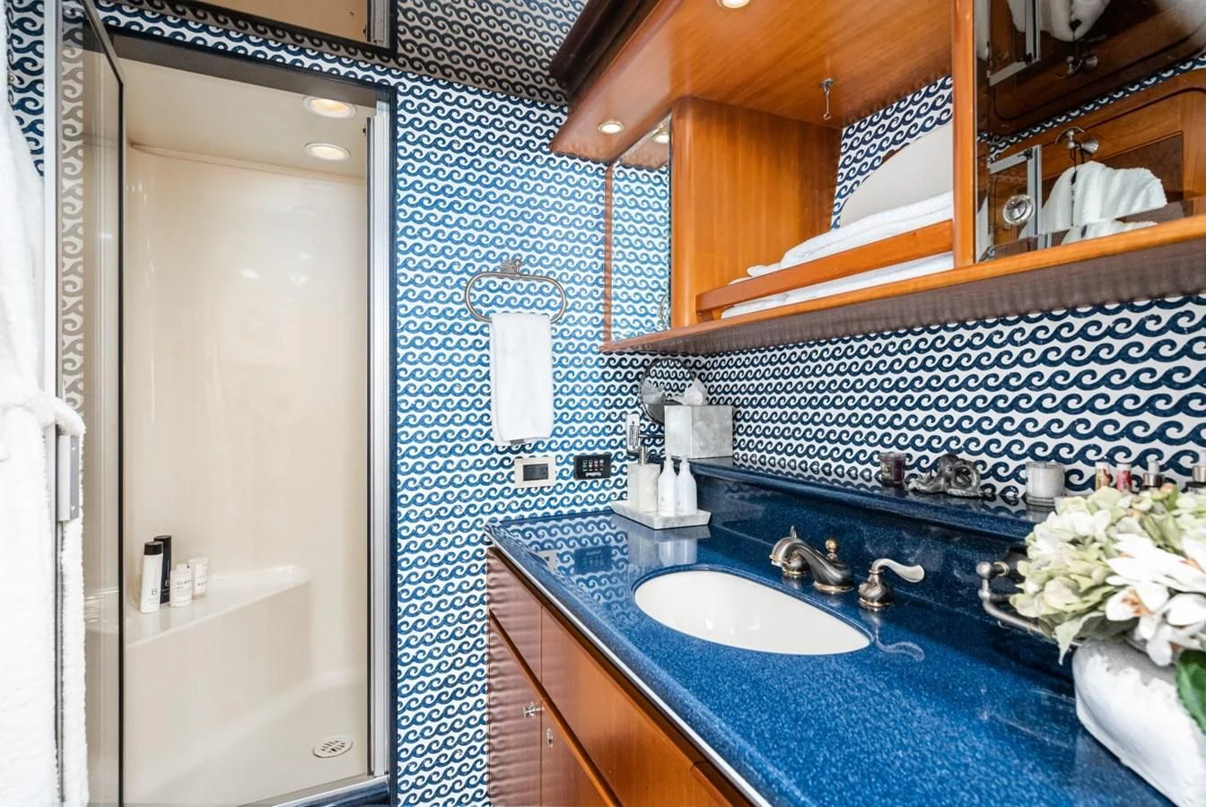 a bathroom with a sink and a mirror aboard MAHANA Yacht for Sale