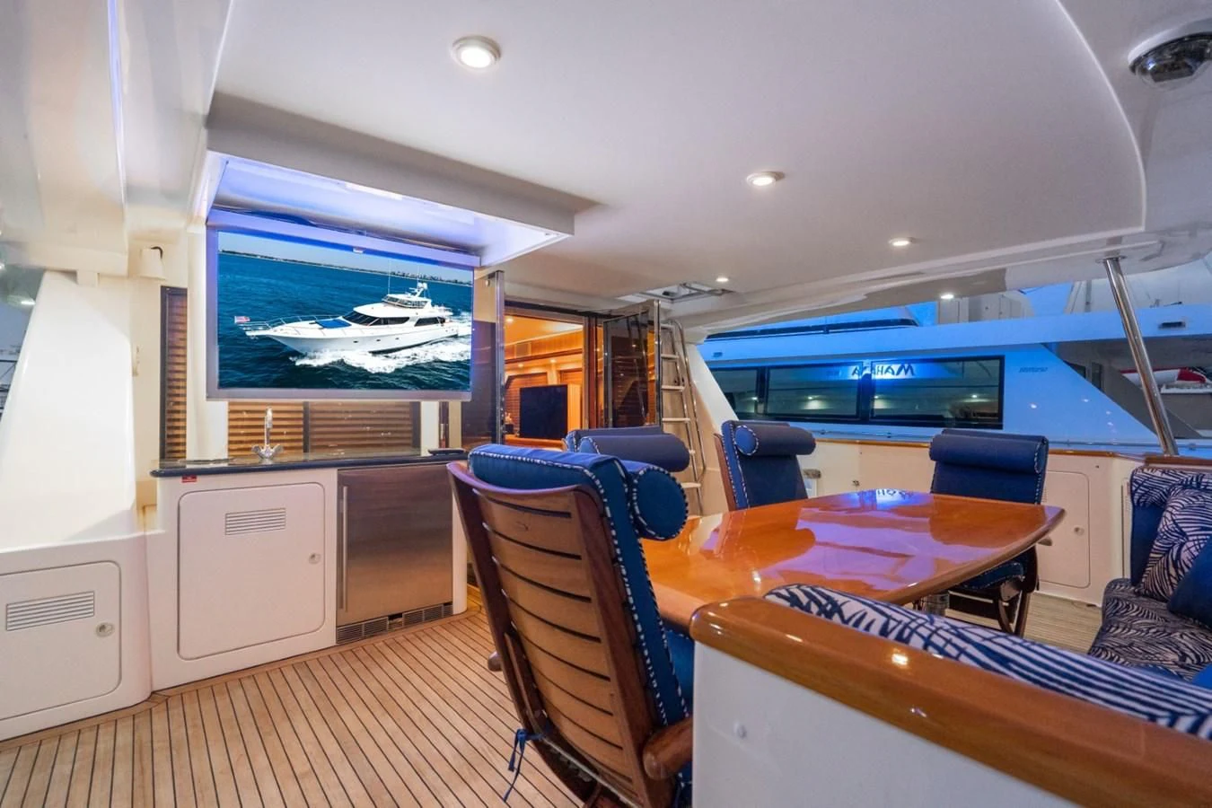 a large room with a table and chairs aboard MAHANA Yacht for Sale
