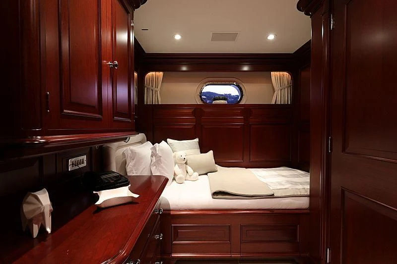 a room with a bed and a desk aboard PREDICTION Yacht for Sale
