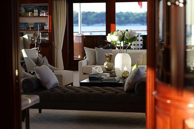 a living room with a couch and a vase of flowers aboard PREDICTION Yacht for Sale