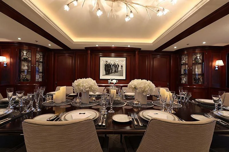 a dining room with a table set aboard PREDICTION Yacht for Sale