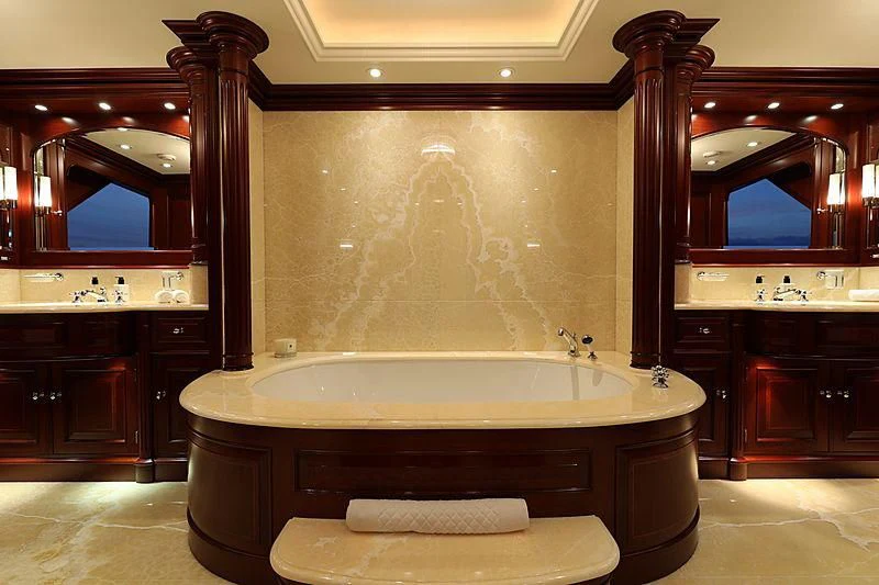 a bathroom with a bathtub and a mirror aboard PREDICTION Yacht for Sale