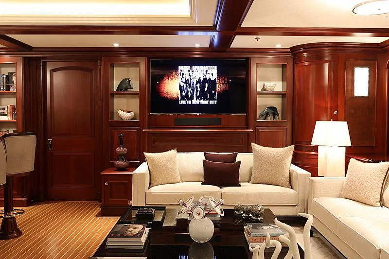 a living room with a large screen aboard PREDICTION Yacht for Sale