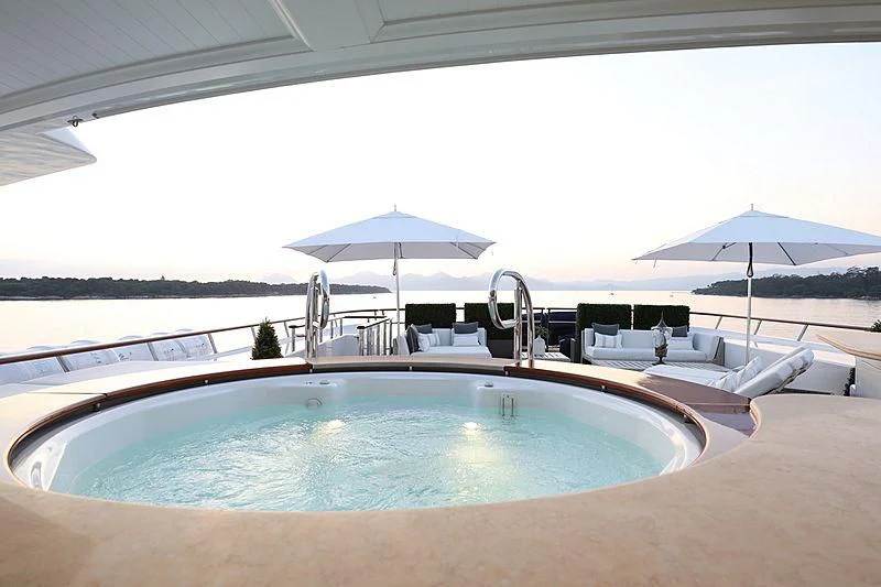 a pool with umbrellas and chairs aboard PREDICTION Yacht for Sale