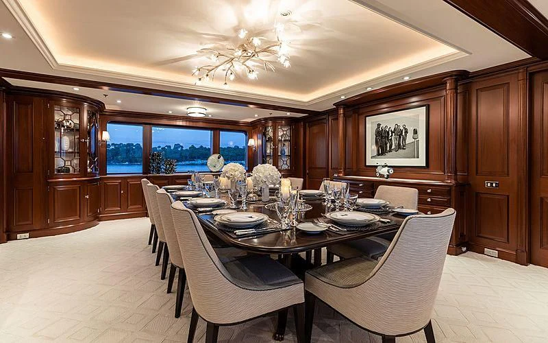 a dining room with a table set aboard PREDICTION Yacht for Sale