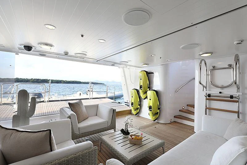 a boat with a table and chairs aboard PREDICTION Yacht for Sale