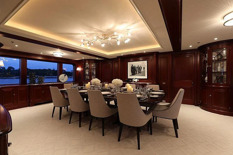 a large dining room with a large table and chairs aboard PREDICTION Yacht for Sale