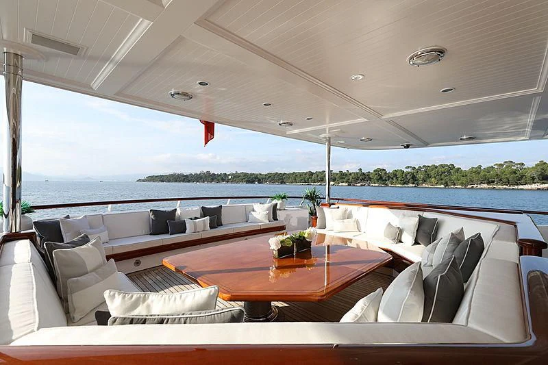 a room with a table and chairs aboard PREDICTION Yacht for Sale