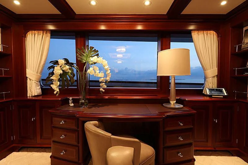 a room with a desk and a tv aboard PREDICTION Yacht for Sale