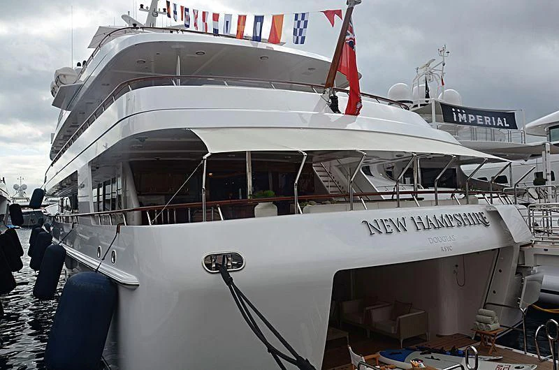 a large white boat with flags on it aboard PREDICTION Yacht for Sale