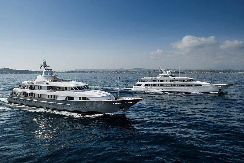 a couple of white boats on water aboard PREDICTION Yacht for Sale