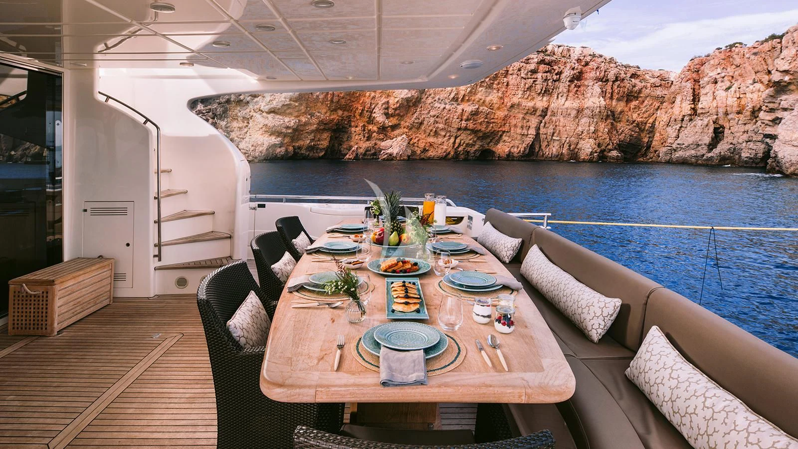 a table set for a meal on a boat aboard MELI Yacht for Charter
