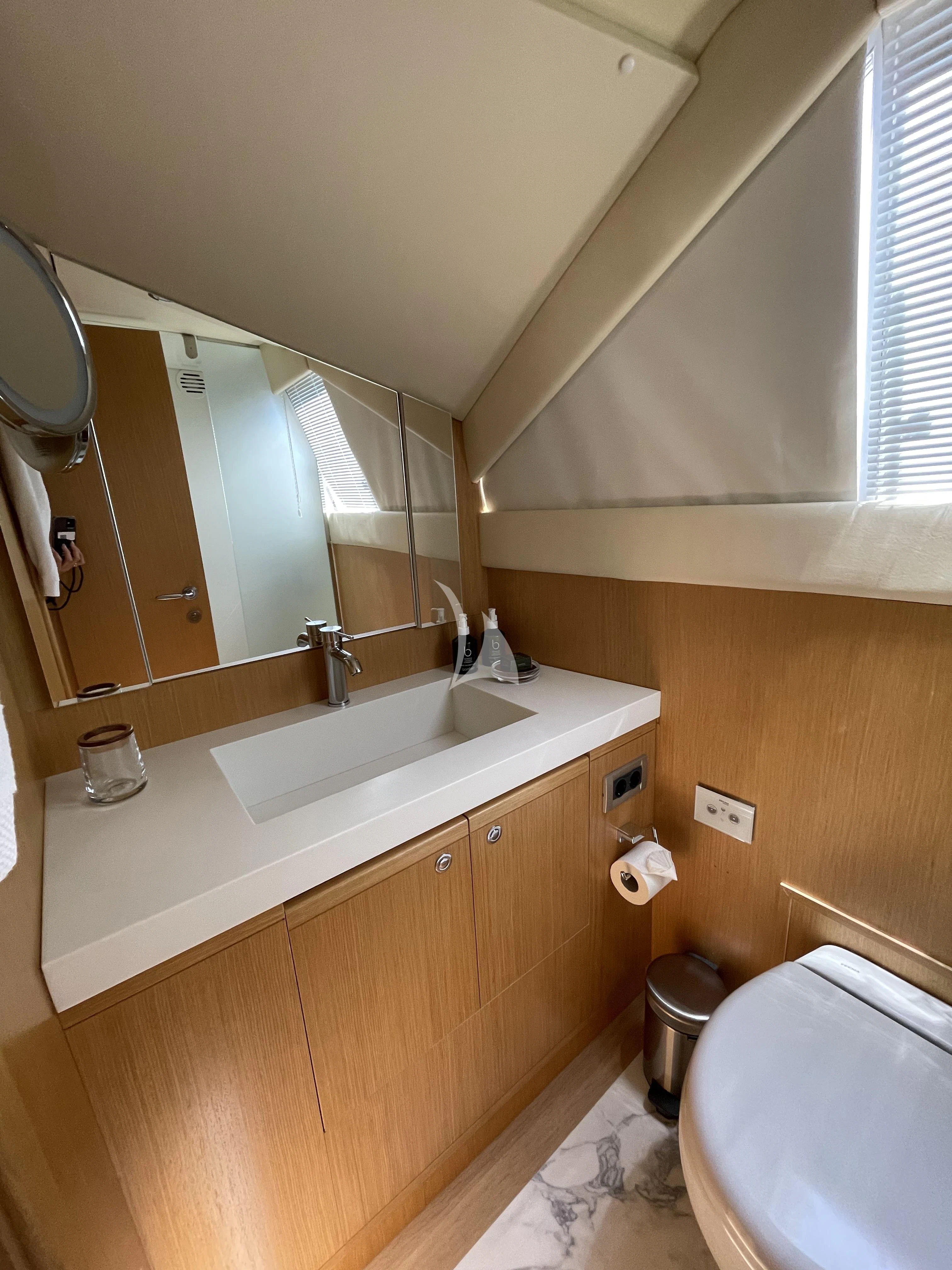 a bathroom with a large mirror aboard MELI Yacht for Charter