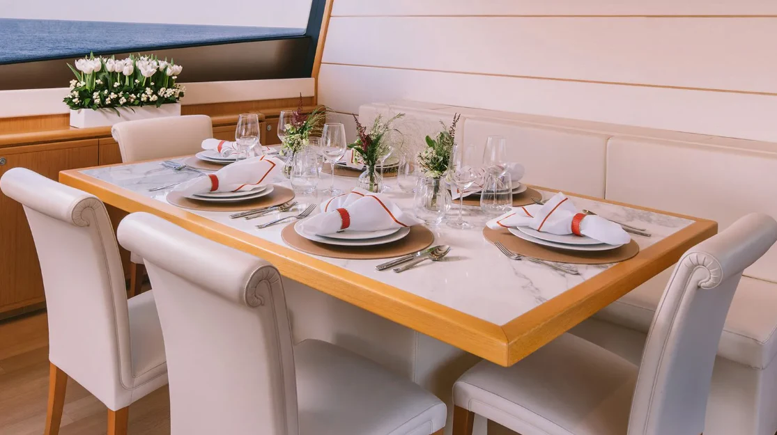 a table set for a dinner aboard MELI Yacht for Charter