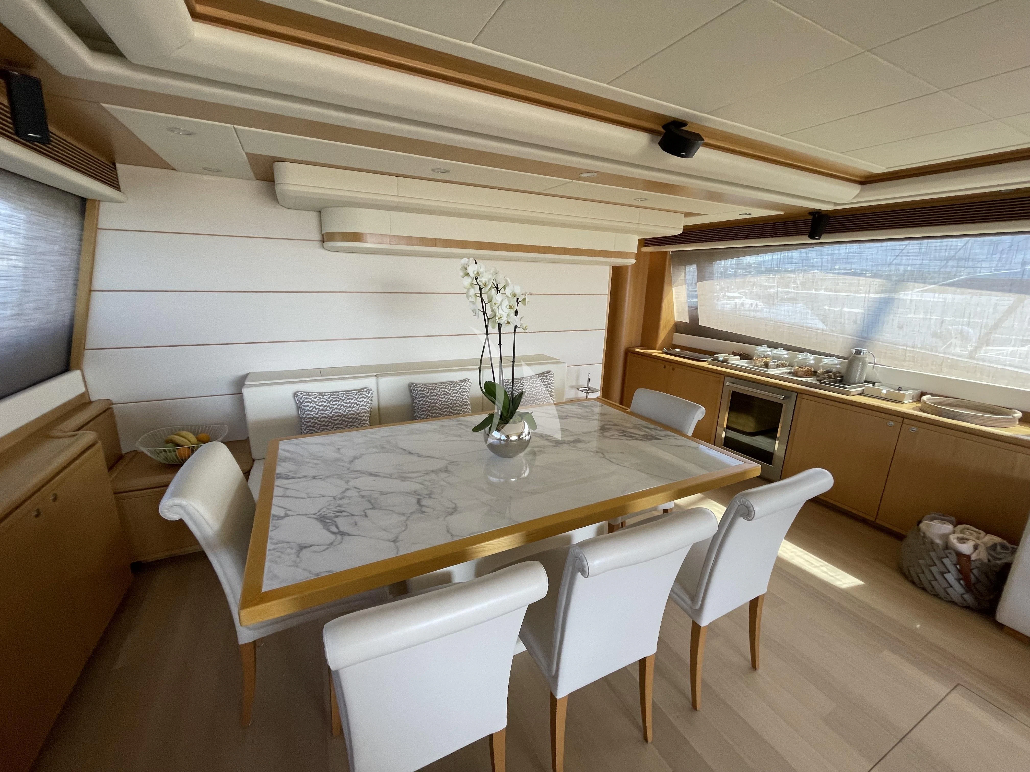 a kitchen with a table and chairs aboard MELI Yacht for Charter