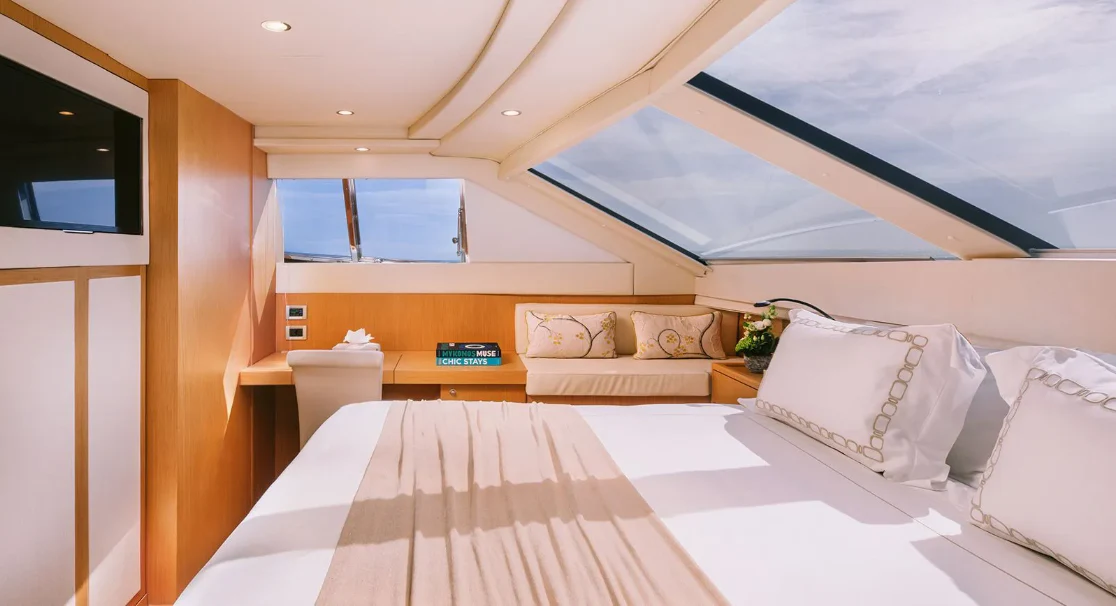 a room with a bed and a window aboard MELI Yacht for Charter