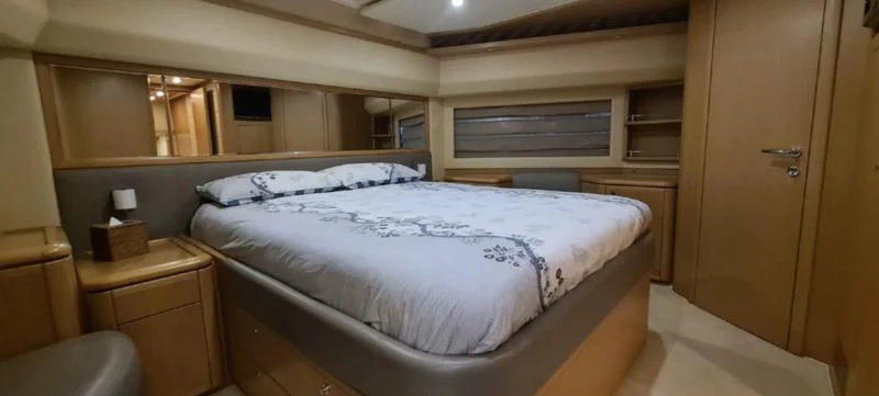 a room with a bed and a desk aboard MELI Yacht for Charter