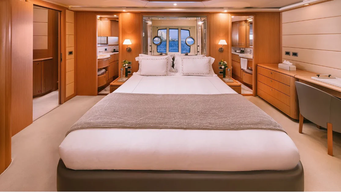 a large bed in a hotel room aboard MELI Yacht for Charter