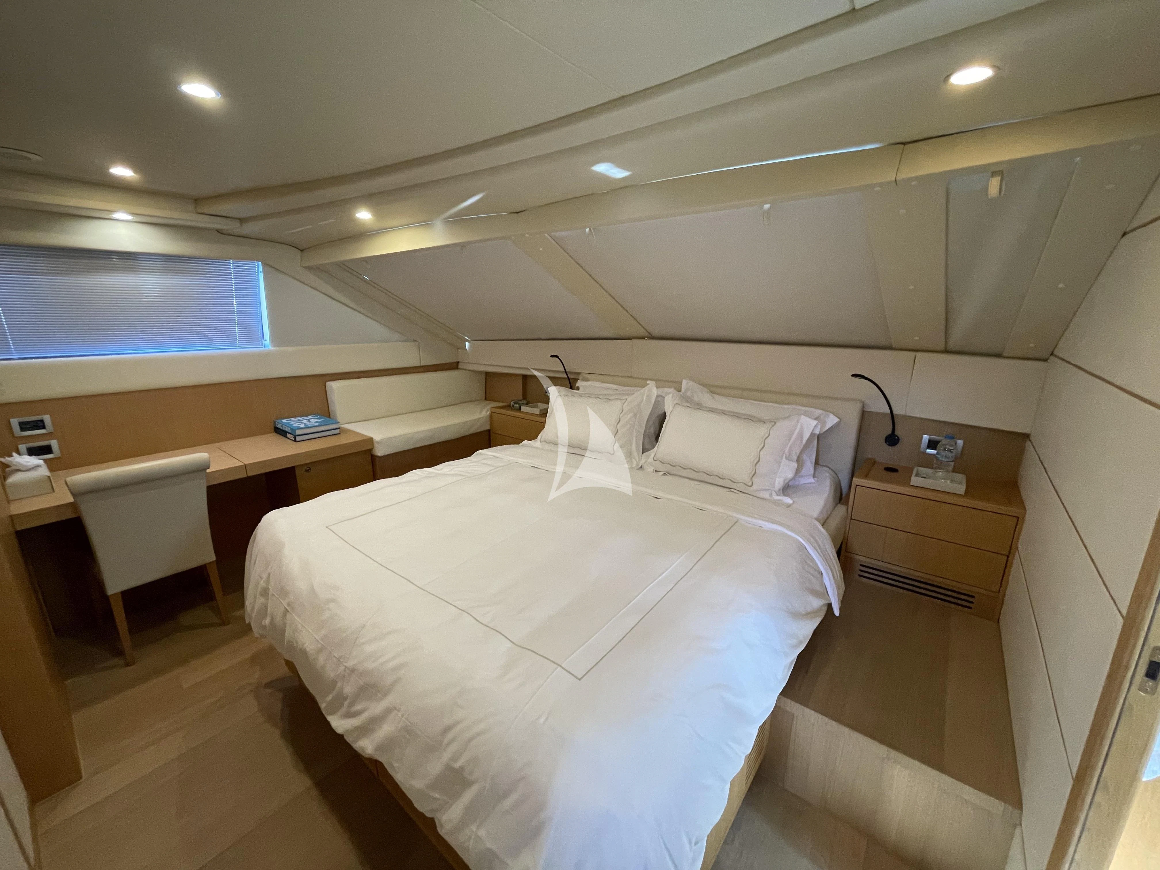 a room with a bed and desk aboard MELI Yacht for Charter
