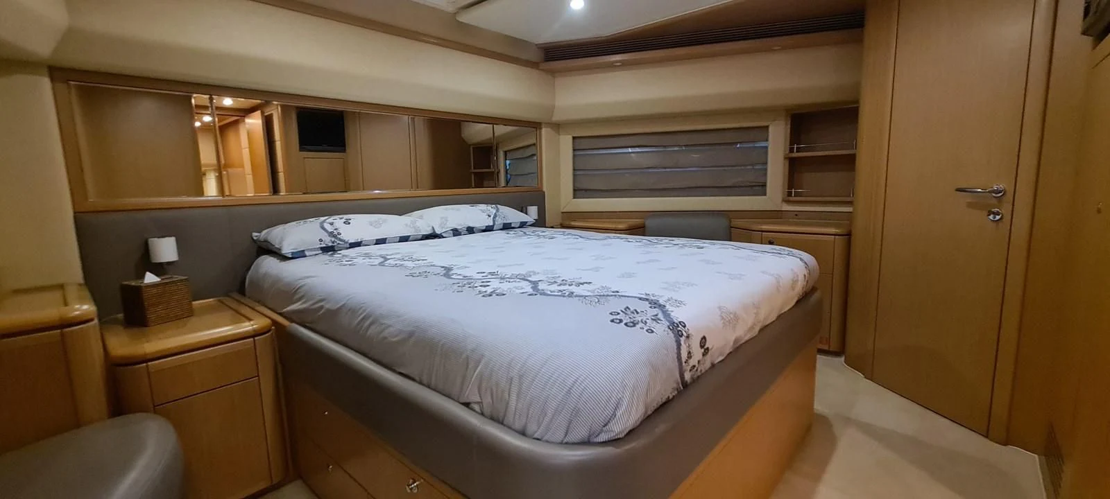 a room with a bed and a desk aboard MELI Yacht for Charter